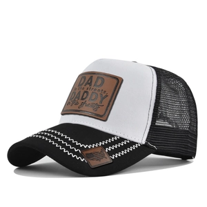 Close-up of trucker hat with DAD leather patch and breathable mesh back details