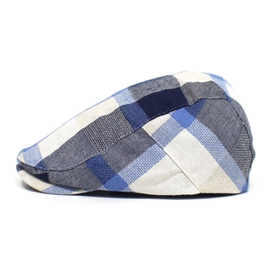 Detail of multi-color plaid patchwork fabric and fine texture on a retro flat cap