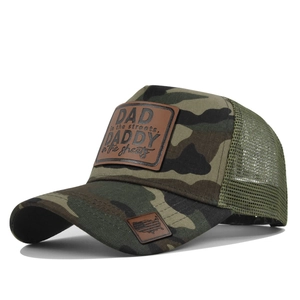 Detail of forest camo trucker hat with leather patch and breathable mesh structure