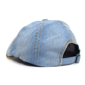 Detail of light blue denim hat back with adjustable metal buckle and yellow stitching