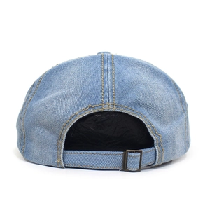 Detail view of light blue denim hat with adjustable strap and brass metal buckle