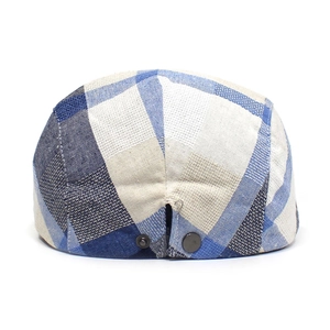 Detail of adjustable metal buckles and fabric texture on a checkered ivy cap