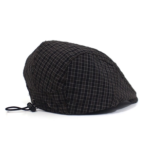 Detail of adjustable elastic drawstring and grid texture on a quick-dry flat cap