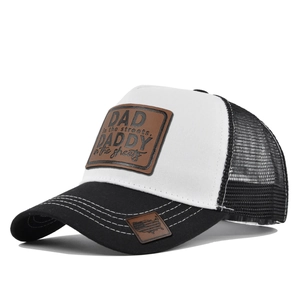Detail of truck hat showing brown leather patch and white stitching on black brim