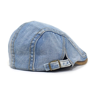 Detailed back view of a washed blue denim beret featuring adjustable metal buckle and stitching
