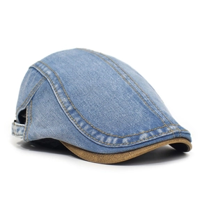 Detail of vintage denim flat cap featuring brown faux leather trim and yellow stitching