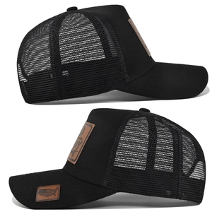 Detail view of black trucker hat with brown leather patch and breathable mesh back