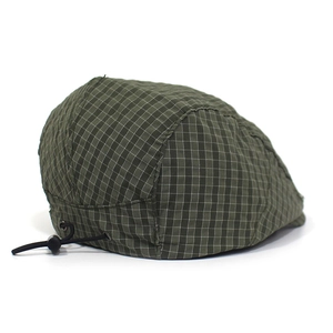 Detail of adjustable drawstring toggle on dark green plaid quick-dry beret cap