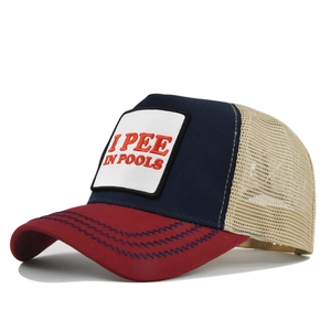 Detailed close-up of navy and red trucker hat with I PEE IN POOLS slogan and mesh back