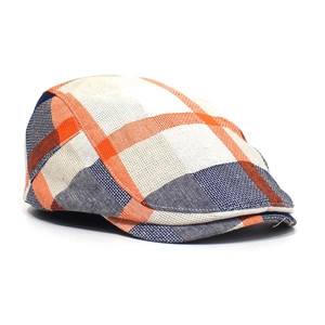 Detail of the colorful plaid flat cap showing orange and navy cotton blend texture