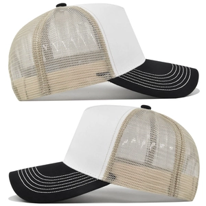 Detail of contrast stitch visor and breathable mesh panel on a two-tone trucker cap