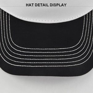 Detailed macro view of black baseball cap brim with six rows of white contrast stitching