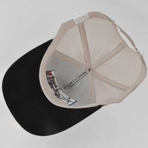 Close-up of internal stitching and 80% cotton wash label of the mesh trucker cap