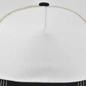 Macro detail of white twill fabric texture and black stitching on a 5-panel baseball cap