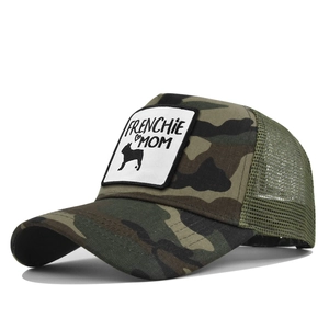 Detail view of camouflage trucker hat with Frenchie Mom patch and green breathable mesh