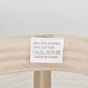 Detailed macro view of the washing label inside a beige 5-panel mesh baseball cap