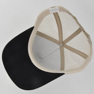 Detail view of trucker hat mesh back and interior label showing 50% cotton material