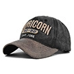 Detail of vintage washed grey cotton baseball cap with Capricorn 3D embroidery and brown brim