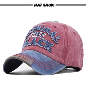 Close-up of vintage washed baseball cap with 3D embroidery and red sawtooth brim stitching