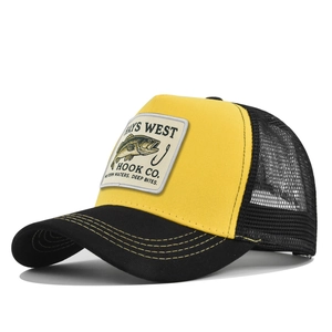Detail of a yellow and black mesh baseball cap with fish embroidery on a white background