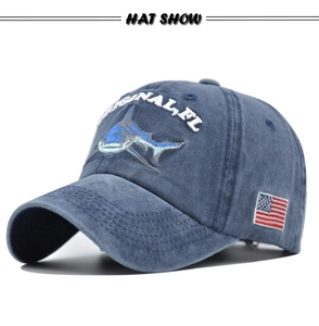 Close-up of 3D shark embroidery and American flag patch on washed cotton baseball cap