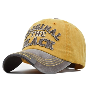Detailed close-up of 3D embroidery and distressed fabric on a vintage baseball cap