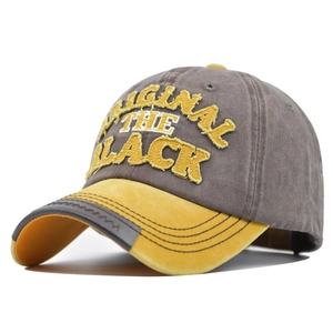 Close-up of 3D embroidered ORIGINAL text on vintage washed grey and yellow baseball cap