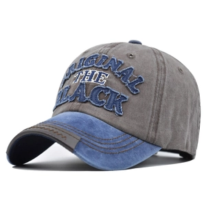 Detailed view of 3D embroidery on washed cotton baseball cap with vintage finish
