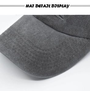 Detail showing curved multi-row stitching and washed dark grey fabric of the baseball cap