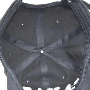 Detailed interior view of black cotton baseball cap showing reinforced seams and eyelets