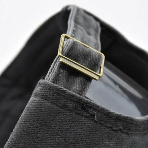 Detail of vintage washed grey baseball cap with antique bronze metal adjustment buckle