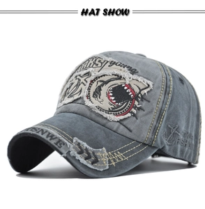Detail showing the shark 3D embroidery and vintage washed texture on the grey baseball cap