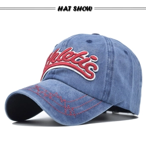 Detail of vintage washed denim baseball cap featuring red 3D athletic's embroidery