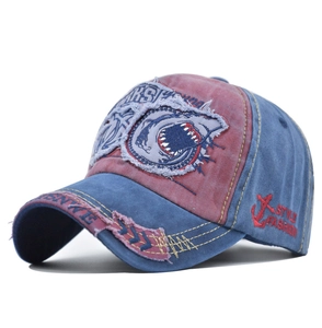 Detailed close-up of 3D shark embroidery and distressed fabric on vintage baseball cap