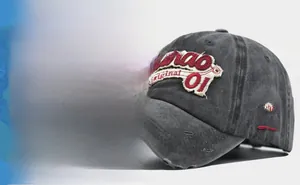 Detail of 3D embroidery on vintage washed cotton baseball cap with distressed hole effects