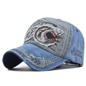 Detail view of washed cotton baseball cap with 3D shark embroidery and distressed edges