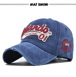 Detail of vintage washed navy baseball cap with 3D embroidery and distressed brim