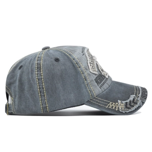 Detailed side view of distressed gray baseball cap featuring vintage washed texture and yellow stitching