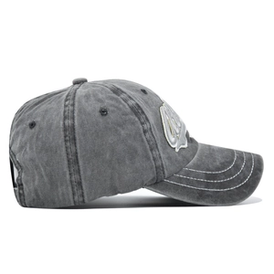 Detail of dark grey washed cotton baseball cap with four-row contrast stitching on the brim