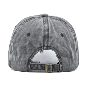 Detail of washed cotton baseball cap with adjustable metal buckle and ventilation holes