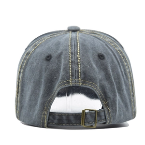 Detail view of washed cotton baseball cap with contrast stitching and adjustable metal buckle