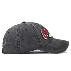 Detailed side view of washed dark gray denim baseball cap with 3D embroidery and vintage wear