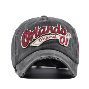 Close-up of vintage washed gray baseball cap featuring 3D Orlando embroidery and frayed brim