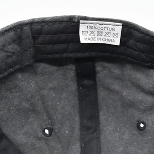 Detail view of the 100 percent cotton care label inside a vintage baseball cap