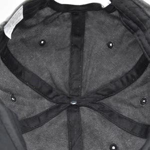 Detailed macro view of the 6-panel interior construction of a washed cotton baseball cap