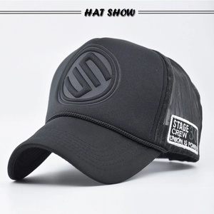 Close-up of black mesh trucker hat with 3D embossed logo and side woven badge detail