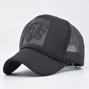 Detail view of black mesh trucker hat with 3D tiger head embossed patch and rope trim