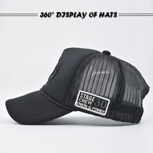 Close-up of black mesh trucker hat featuring a rectangular Stage Crew side patch