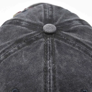 Macro view of top button and precision stitching on washed cotton baseball cap