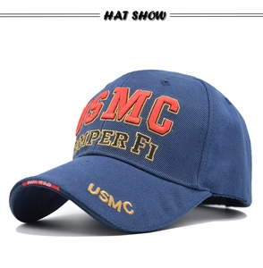 Detail of navy blue USMC tactical baseball cap with red embroidered letters and gold trim